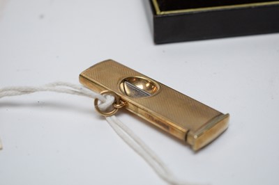 Lot 233 - A 9ct yellow gold mounted cigar cutter, and a gilt metal Dunhill lighter