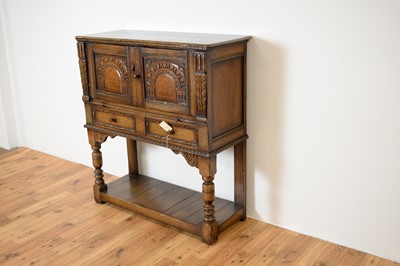 Lot 35 - Manner of Titchmarsh & Goodwin: a Jacobean Revival oak cabinet on stand / buffet