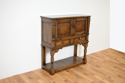 Lot 35 - Manner of Titchmarsh & Goodwin: a Jacobean Revival oak cabinet on stand / buffet