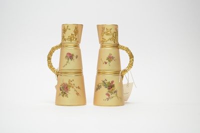 Lot 396 - Two Royal Worcester blush ivory tapering jugs.