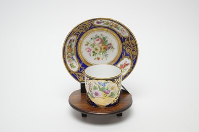 Lot 422 - A Minton tea cup and saucer, similarly decorated in mahogany stand.