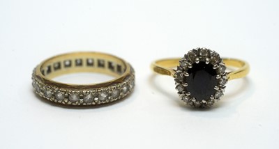 Lot 196 - A sapphire and diamond cluster ring, and an eternity ring