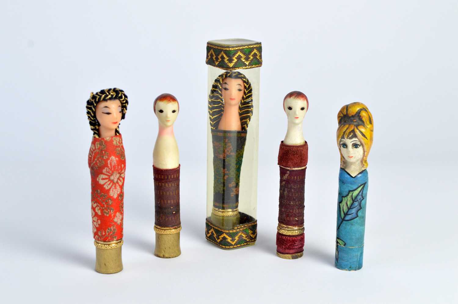 Lot 140 - 1960s Revlon "Couturine" doll lipstick holders