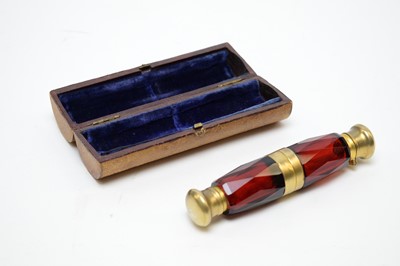 Lot 143 - A Victorian novelty ruby faceted double-ended scent bottle, forming the shape of opera glasses
