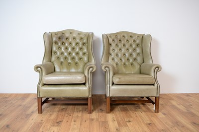 Lot 70 - A pair of 20th Century wingback armchairs upholstered in light green leatherette