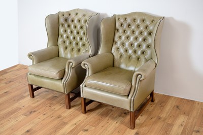 Lot 70 - A pair of 20th Century wingback armchairs upholstered in light green leatherette