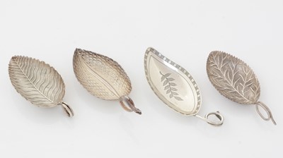 Lot 179 - A George III silver caddy spoon and three other George III silver leaf caddy spoons
