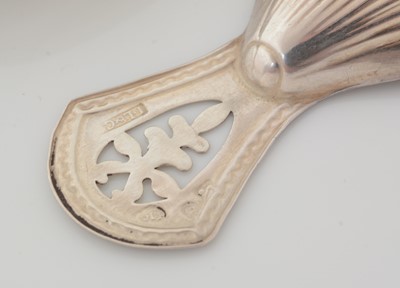 Lot 194 - A Victorian silver provincial fiddle-pattern caddy spoon and a Sheffield-made silver caddy spoon