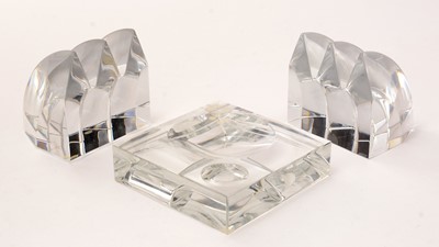 Lot 849 - Baccarat, France: a clear glass near pair of book ends and a dish
