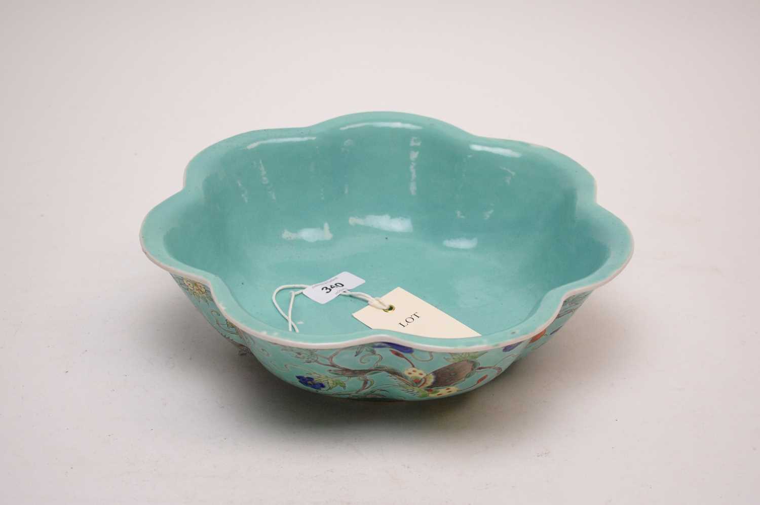 Lot 340 - A Chinese scalloped circular bowl, decorated with butterflies, flowers and foliage.