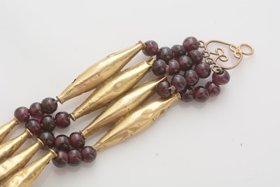 Lot 700 - An Egyptian yellow gold and garnet necklace
