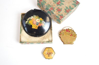 Lot 43 - 1920s powder compacts depicting baskets of blooms