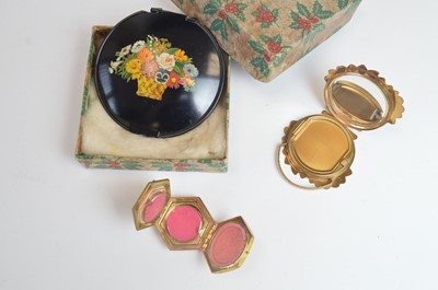 Lot 43 - 1920s powder compacts depicting baskets of blooms