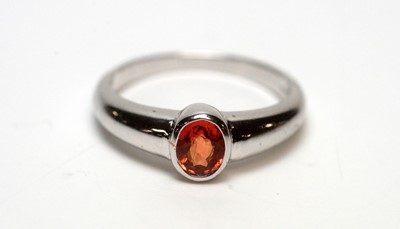 Lot 216 - An orange sapphire ring