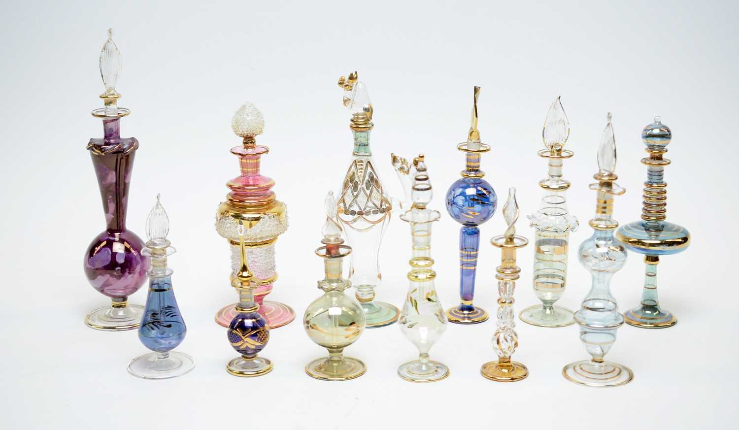 Lot 198 - A collection of Egyptian hand-blown glass perfume bottles