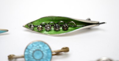 Lot 96 - A selection of silver and enamel brooches and a pendant.