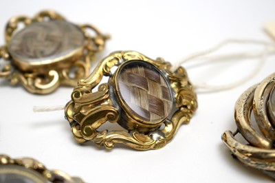 Lot 106 - Seven Victorian mourning brooches, and a picture pendant.
