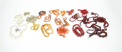 Lot 121 - A selection of amber style bead necklaces; and mother of pearl necklaces.