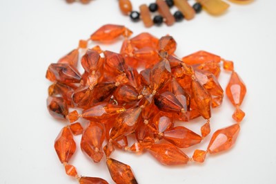 Lot 121 - A selection of amber style bead necklaces; and mother of pearl necklaces.