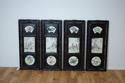 Lot 792 - A set of four Chinese oriental decorative ebonised hardwood and porcelain panels