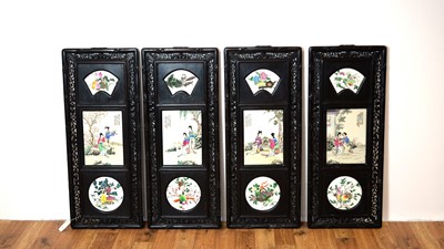 Lot 858 - A set of four Chinese oriental decorative ebonised hardwood and porcelain panels