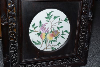 Lot 858 - A set of four Chinese oriental decorative ebonised hardwood and porcelain panels