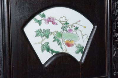 Lot 858 - A set of four Chinese oriental decorative ebonised hardwood and porcelain panels