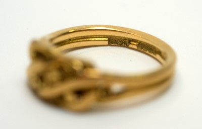 Lot 166 - An 18ct yellow gold wedding band, and an 18ct yellow gold knot pattern ring