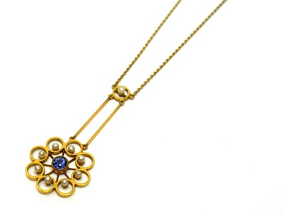 Lot 217 - An Edwardian sapphire and seed pearl pendant
