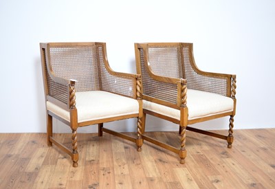 Lot 15 - A pair of early 20th Century walnut bergere rattan armchairs
