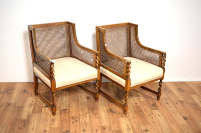 Lot 15 - A pair of early 20th Century walnut bergere rattan armchairs