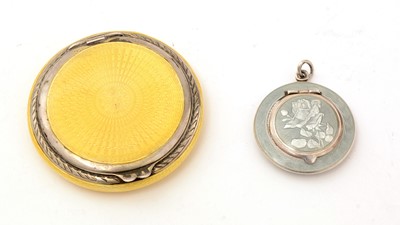 Lot 335 - A George V silver and lemon-yellow compact and a smaller continental silver compact