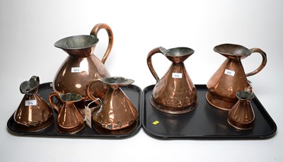 Lot 398 - A graduated composite set of seven Victorian copper harvest measure jugs.