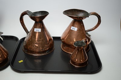 Lot 398 - A graduated composite set of seven Victorian copper harvest measure jugs.