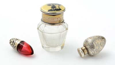 Lot 293 - A George V silver mounted cut-glass smelling salts bottle; and two others