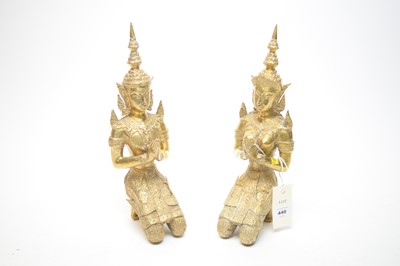 Lot 440 - A pair of Eastern seated brass Buddha figures, comprising a male and female.