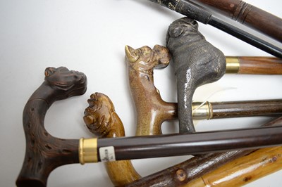 Lot 462 - A selection of 20th Century walking sticks, each with bulldog head handle, most carved