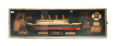 Lot 266 - A Titanic commemorative maritime display case, containing a half block style model ship