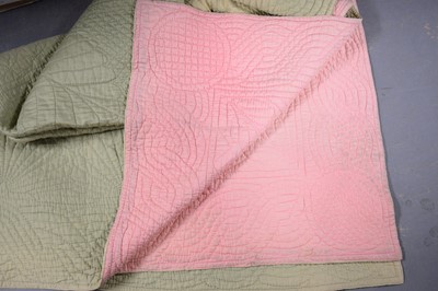 Lot 304 - A two-tone Durham quilt, in lime green and pink.