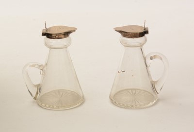 Lot 12 - A pair of George V silver-mounted clear glass whisky tots or chota pegs