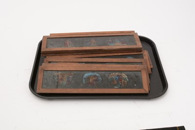 Lot 22 - A collection of fourteen handpainted Victorian mahogany framed magic lantern slides