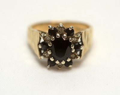 Lot 139 - A topaz and diamond and sapphire and diamond ring