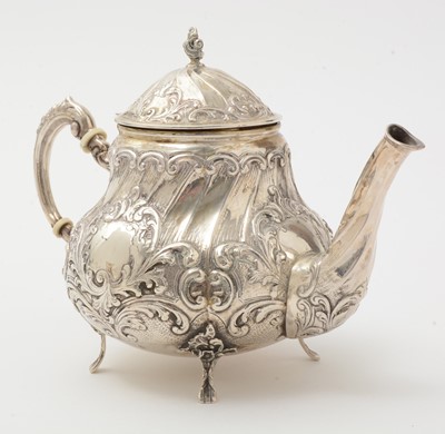 Lot 117 - A 20th Century German silver cream jug and covered sugar bowl; and a silver teapot