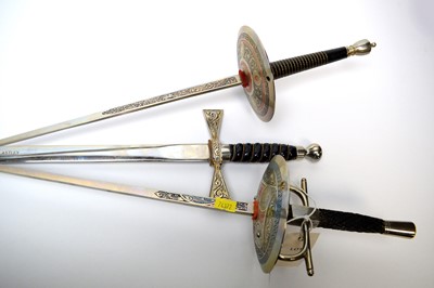 Lot 251 - Two enamelled fencing sabres; together with a presentation sword