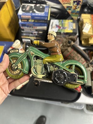 Lot 323 - A clockwork tinplate motorcycle and rider figure and three others