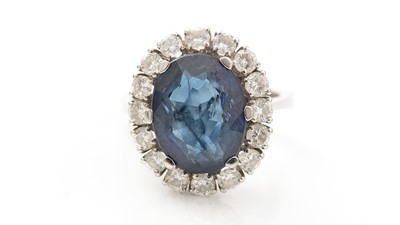 Lot 555 - A sapphire and diamond cluster ring