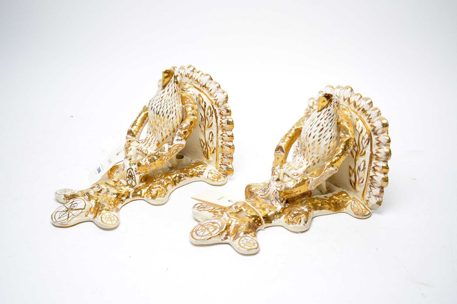 Lot 396 - A pair of Staffordshire wall sconces