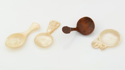 Lot 249 - A burr-wood caddy spoon; together with three carved mother-of-pearl caddy spoons