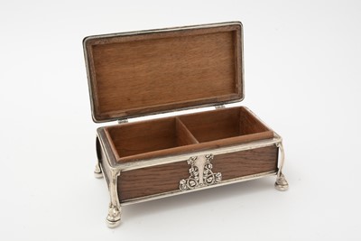 Lot 347 - An Edwardian/George V arts and crafts silver mounted oak cigarette casket