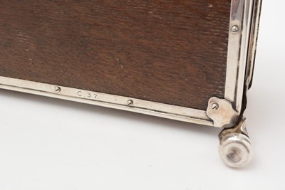 Lot 347 - An Edwardian/George V arts and crafts silver mounted oak cigarette casket